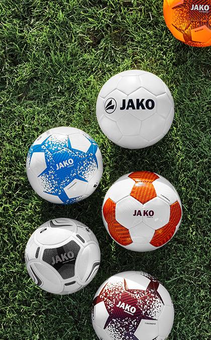 Coach discussing strategy with basketball players during a team huddle indoors.